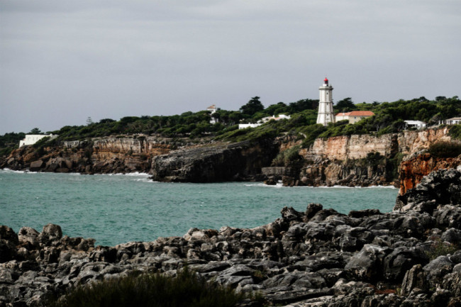 A view of the cliffs, the Atlantic Ocean and a lighthouse at Boca do Inferno in Cascais, Portugal. Cascais is a city and municipality in the Greater Lisbon region, located on the Portuguese Riviera, a major tourist destination and has many international residents. [Photo: IC]