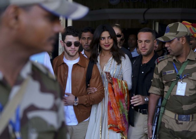 Bollywood actress Priyanka Chopra, center right and musician Nick Jonas, center left, arrive at the airport in Jodhpur, Rajasthan, India, Thursday, Nov.29, 2018. The couple who in August announced on their respective Instagram accounts that they are engaged are reportedly here for their wedding. [Photo: AP]