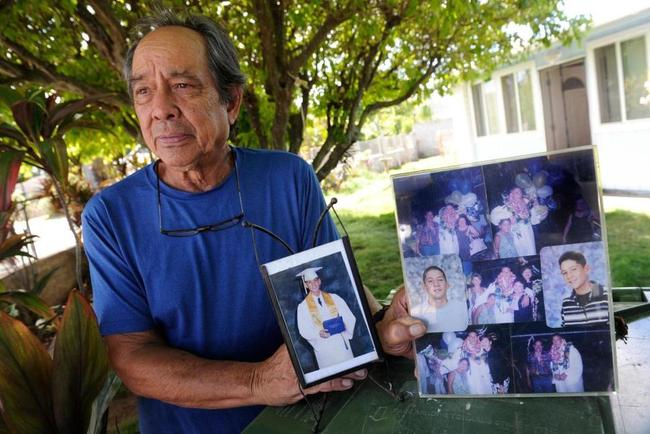 In this July 10, 2017, file photo, Clifford Kang, father of soldier Ikaika E. Kang, poses with photos of his son in Kailua, Hawaii. [File photo: AP]