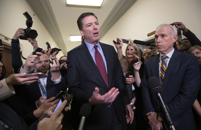 Former FBI Director James Comey, with his attorney, David Kelley, right, speaks to reporters after a day of testimony before the House Judiciary and Oversight committees, on Capitol Hill in Washington, Friday, Dec. 7, 2018. [Photo: AP/J. Scott Applewhite]