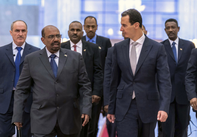 In this photo released by the Syrian official news agency SANA, Syrian President Bashar Assad, right, meets with Sudan's President Omar al-Bashir in Damascus, Syria, Sunday, Dec. 16, 2018. [Photo: AP/ Provided by SANA]