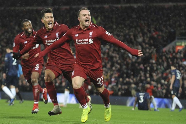 Liverpool's Xherdan Shaqiri, right, celebrates after scoring his side's third goal during the English Premier League soccer match between Liverpool and Manchester United at Anfield in Liverpool, England, Sunday, Dec. 16, 2018. [Photo: AP]