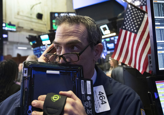 In this Dec. 12, 2018, file photo trader Gregory Rowe works at the New York Stock Exchange, Wednesday, Dec. 12, 2018, in New York. [File photo: AP/Mark Lennihan]
