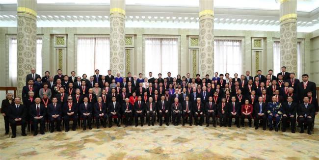 Chinese President Xi Jinping, also general secretary of the Communist Party of China (CPC) Central Committee and chairman of the Central Military Commission, and other Chinese leaders pose for group photos with the personnel awarded for their outstanding contributions to the reform and opening-up and their relatives after a grand gathering to celebrate the 40th anniversary of China's reform and opening-up at the Great Hall of the People in Beijing, capital of China, Dec. 18, 2018. Xi made an important speech at the gathering. [Photo: Xinhua/Xie Huanchi]