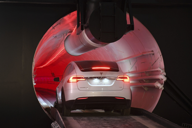 A modified Tesla Model X drives in the tunnel entrance before an unveiling event for the Boring Co. Hawthorne test tunnel in Hawthorne, Calif., Tuesday, Dec. 18, 2018. [Photo: Pool via AP/Robyn Beck]