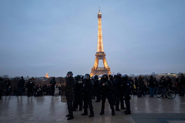 French riot police officers take position on the Trocadero plaza during a demonstration in Paris, Saturday, Dec. 29, 2018. Yellow vest protesters marched on the headquarters of leading French broadcasters Saturday, as small groups turned out around France despite waning momentum for their movement. Police arrested some protesters near the Eiffel Tower, but by nightfall calm returned to the area. [Photo: AP/Kamil Zihnioglu]