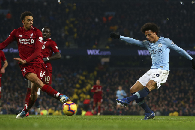 Manchester City's Leroy Sane, right, shoots to score his side's second goal during the English Premier League soccer match between Manchester City and Liverpool at the Etihad Stadium in Manchester, England, Thursday, Jan. 3, 2019. [Photo: AP]
