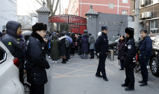 olicemen stand guard outside Xuanwu Normal Experimental Affiliated Number One Primary School, after 20 primary school pupils were wounded in an attack at the school in Beijing on January 8, 2019. [Photo: IC]
