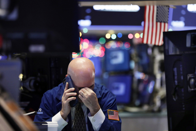 A trader talks on his phone on the floor of the New York Stock Exchange, Wednesday, Jan. 2, 2019. [File photo: AP/Richard Drew]