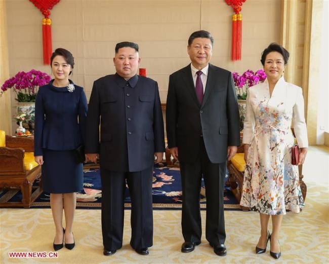 Xi Jinping (2nd R), general secretary of the Central Committee of the Communist Party of China and Chinese president, and his wife Peng Liyuan (1st R) pose for photos with Kim Jong Un (2nd L), chairman of the Workers' Party of Korea and chairman of the State Affairs Commission of the Democratic People's Republic of Korea, and his wife Ri Sol Ju at Beijing Hotel in Beijing, capital of China, Jan. 9, 2019. Xi Jinping on Tuesday held talks with Kim Jong Un, who arrived in Beijing on the same day for a visit to China. On Wednesday, Xi Jinping met with Kim Jong Un at Beijing Hotel. [Photo: Xinhua]