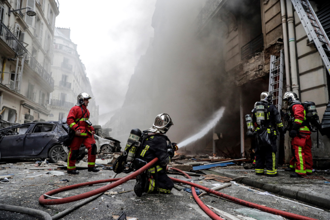 Firefighters extinguish a fire after the explosion of a bakery on the corner of the streets Saint-Cecile and Rue de Trevise in central Paris on January 12, 2019. [Photo: AFP/Thomas Samson]
