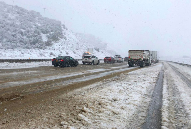 This photo provided by the California Department of Transportation shows traffic stopped on Interstate 5 where it has been closed due to snow at Tejon Pass, an area known as the Grapevine, at Gorman in the Tehachapi Mountains of Southern California, Monday, Jan. 14, 2019. [Photo: CalTrans via AP]