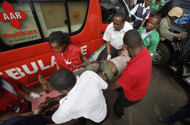 A wounded member of Kenyan special forces with two tourniquets around his legs is carried from a US embassy diplomatic vehicle into an ambulance by paramedics at the scene Wednesday, Jan. 16, 2019 in Nairobi, Kenya. Extremists stormed a luxury hotel in Kenya's capital on Tuesday, setting off thunderous explosions and gunning down people at cafe tables in an attack claimed by Africa's deadliest Islamic militant group. [Photo: AP/Ben Curtis]