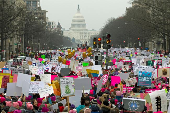 Demonstrators hold signs on Pennsylvania Avenue during the Women's March in Washington on Saturday, Jan. 19, 2019. [Photo: AP/Jose Luis Magana]