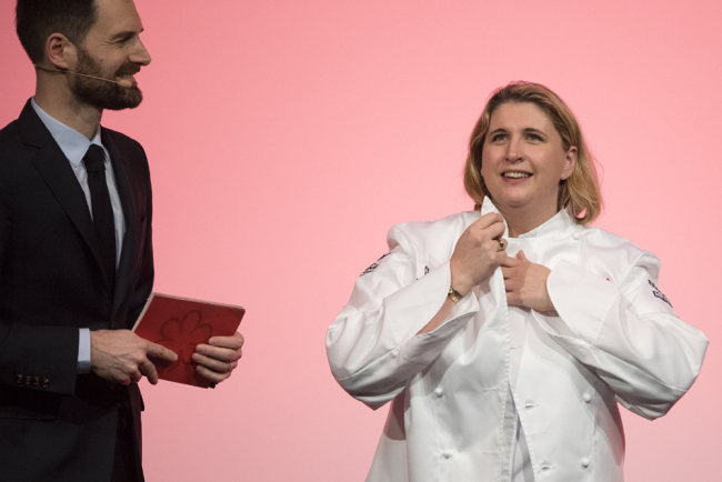 Chef Stephanie Le Quellec (R) is flanked by Michelin guide international director Gwendal Poullenec as she reacts on stage after she was awarded two Michelin stars during the Michelin guide award ceremony in Paris on January 21, 2019. [Photo: AFP]