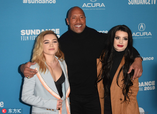 From left to right, cast members Florence Pugh, producer and cast member Dwayne Johnson, and WWE's Paige pose at the premiere of the film "Fighting With My Family" during the 2019 Sundance Film Festival, Monday, Jan. 28, 2019, in Park City, Utah. [Photo：IC] 