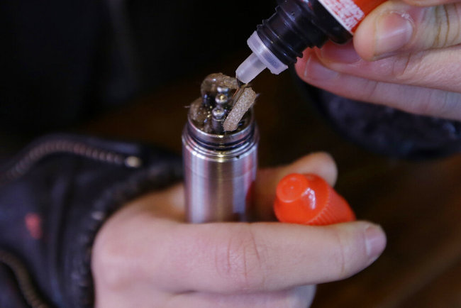 In this Feb. 20, 2014 file photo, a liquid nicotine solution is poured into a vaping device at a store in New York. According to a study released on Wednesday, Jan. 30, 2019, twice as many people successfully quit smoking using electronic cigarettes than older nicotine gums and patches, providing the strongest evidence yet that vaping can help smokers break their addiction to cigarettes. [File photo: AP]