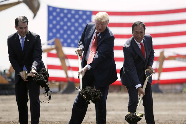 President Donald Trump, center, along with Wisconsin Gov. Scott Walker, left, and Foxconn Chairman Terry Gou participate in a groundbreaking event for the new Foxconn facility in Mt. Pleasant, Wisconsin, on June 28, 2018. [Photo: AP]