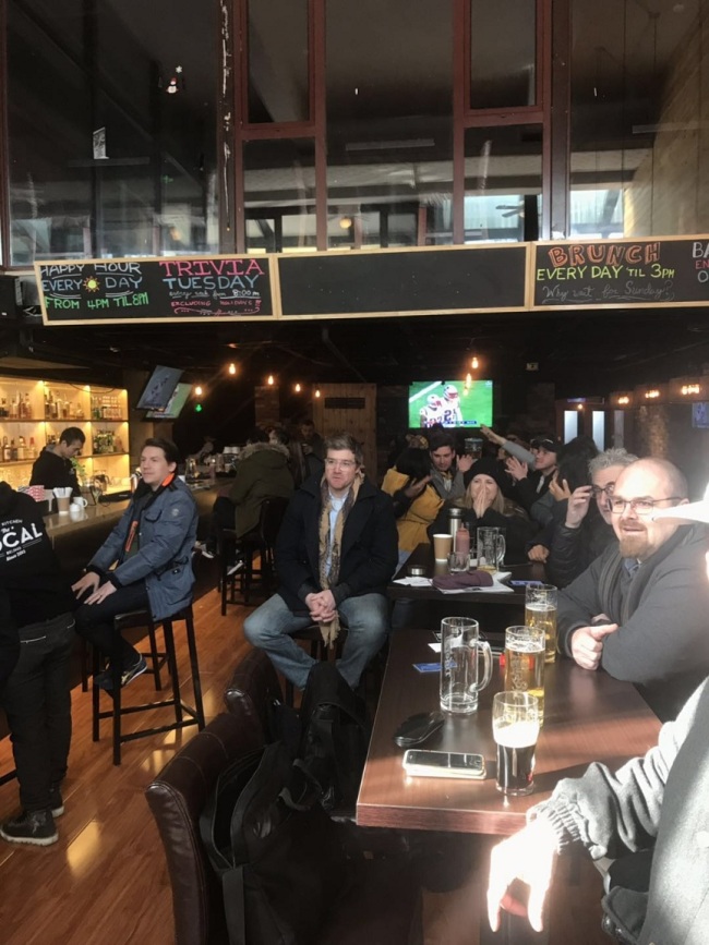 Fans at a popular sports bar in Beijing avidly watch the live Super Bowl game that started around 7:30am Beijing time. [Photo: China Plus]
