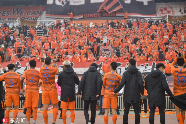 Players of Shandong Luneng celebrate with fans after a 4-1 win over Hanoi FC in the AFC Champions League play-off match in Jinan on Feb 20, 2019. [Photo: IC]