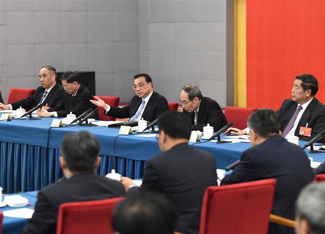 Chinese Premier Li Keqiang, also a member of the Standing Committee of the Political Bureau of the Communist Party of China (CPC) Central Committee, joins a panel discussion with political advisors from the China National Democratic Construction Association and the All-China Federation of Industry and Commerce at the second session of the 13th National Committee of the Chinese People's Political Consultative Conference (CPPCC) in Beijing, capital of China, March 4, 2019. [Photo: Xinhua/Rao Aimin]