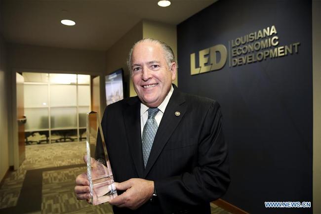 Don Pierson, secretary of Louisiana Economic Development (LED), poses for a photo with the trophy of the Outstanding FDI Partnership Award by the New York-based Chinese General Chamber of Commerce, before an interview with Xinhua in Baton Rouge, Louisiana, the United States, Feb. 27, 2019. [Photo: Xinhua]