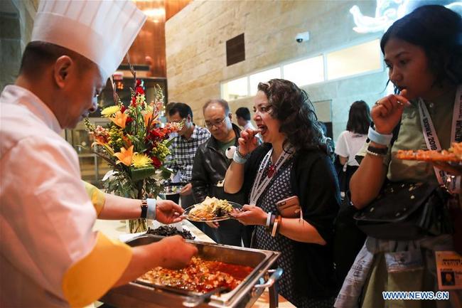 Attendees enjoy the Sichuan style food at an event promoting southwest China's city of Chengdu in the southern U.S. city of Austin, March 8, 2019. [Photo: Xinhua]