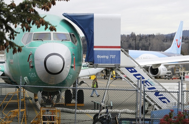 A worker walks near a Boeing 737 MAX 8 being built for for Shanghai Airlines at Boeing Co.'s Renton Assembly Plant, Monday, March 11, 2019, in Renton, Wash. [Photo: IC]