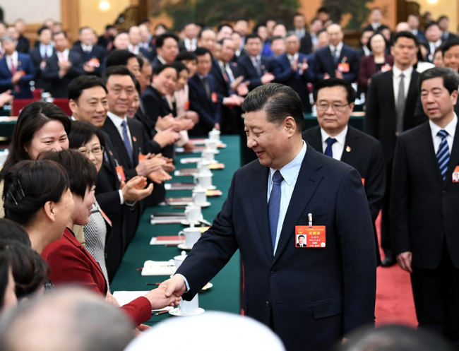 President Xi Jinping shakes hands with a deputy from Henan Province at the second session of the 13th National People's Congress in Beijing on March 8, 2019. [Photo: Xinhua]