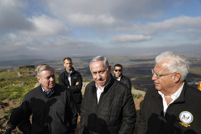 (L to R) US Senator Lindsey Graham (R-SC) is accompanied by Israeli Prime minister Benjamin Netanyahu and US Ambassador to Israel David Friedman as they visit the border line between Syria and the Israeli-annexed Golan Heights on March 11, 2019. The influential US senator allied to President Donald Trump toured the occupied Golan Heights on March 11 and vowed to work to have Washington recognise Israeli sovereignty over the strategic plateau. Graham's pledge was a boost to Prime Minister Benjamin Netanyahu, who toured the Golan with him, ahead of April 9 Israeli elections. [File photo: Pool/AFP/Ronen Zvulun]