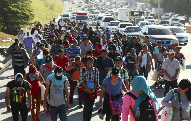 Migrants traveling in a group begin their journey toward the U.S. border as they walk along a highway in San Salvador, El Salvador, Jan. 16, 2019. [Photo: AP/Salvador Melendez]