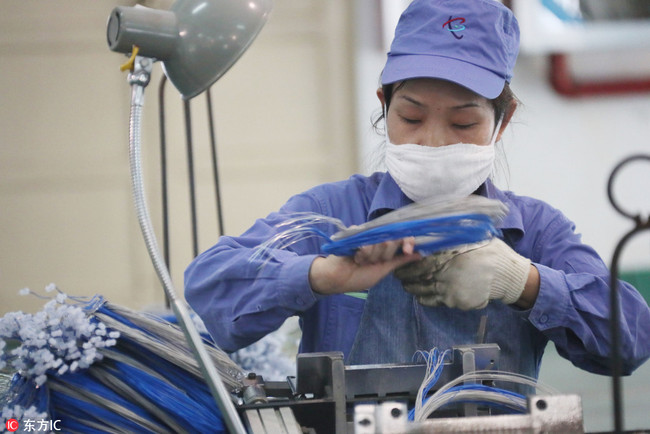 A woman is working in a factory. [File photo: IC]