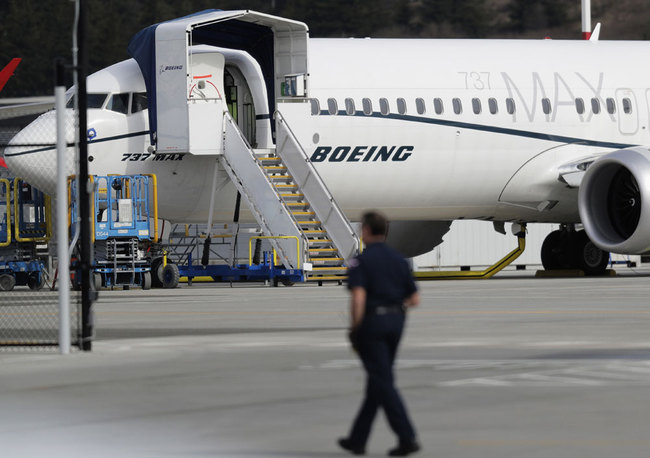 In this March 14, 2019, file photo, a worker walks next to a Boeing 737 MAX 8 airplane parked at Boeing Field in Seattle. U.S. aviation regulators said Monday, April 1, Boeing needs more time to finish changes in a flight-control system suspected of playing a role in two deadly crashes. [File photo: AP/Ted S. Warren]