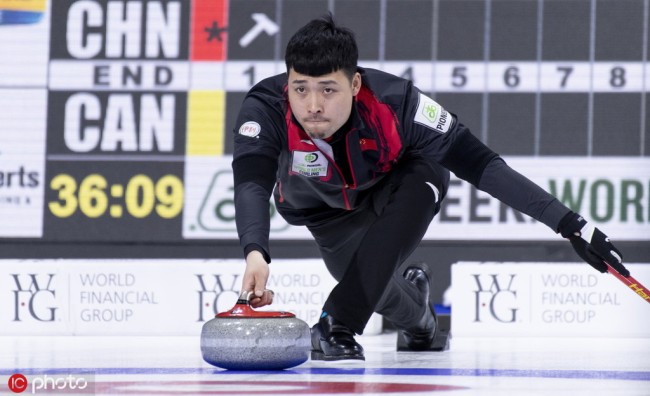 Chinese skip Zou Qiang delivers a rock vs. Canada at the Men's World Curling Championship in Lethbridge, Alberta, Canada, March 31, 2019. [Photo: IC]