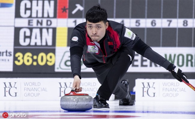 Chinese skip Zou Qiang delivers a rock vs. Canada at the Men's World Curling Championship in Lethbridge, Alberta, Canada, March 31, 2019. [Photo: IC]