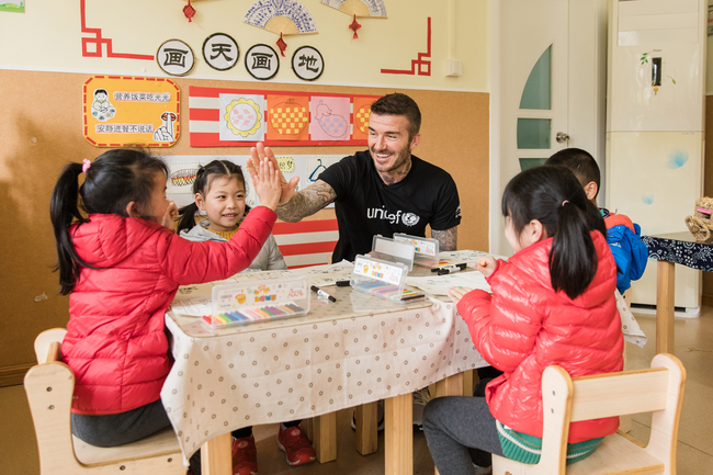 UNICEF Goodwill Ambassador and Global Icon David Beckham high fives with a girl during a visit to Xianghuaqiao Kindergarten on the outskirts of Shanghai, China, on 27th March 2019. [Photo: UNICEF/Ma Yuyuan]