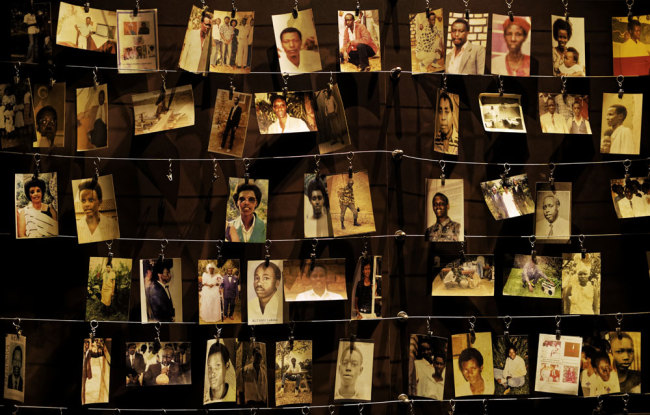 Family photographs of some of those who died hang on display in an exhibition at the Kigali Genocide Memorial centre in the capital Kigali, Rwanda Friday, April 5, 2019. [Photo: AP/Ben Curtis]