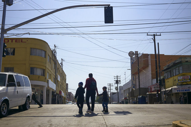 In this March 5, 2019, file photo, Ruth Aracely Monroy walks with her sons in Tijuana, Mexico. After requesting asylum in the United States, the family was returned to Tijuana to wait for their hearing in San Diego. A U.S. judge on Monday, April 8, 2019, blocked the Trump administration's policy of returning asylum seekers to Mexico as they wait for an immigration court to hear their cases but the order won't immediately go into effect. Judge Richard Seeborg in San Francisco granted a request by civil liberties groups to halt the practice while their lawsuit moves forward. He put the decision on hold until Friday, April 12 to give U.S. officials the chance to appeal. [Photo: AP]