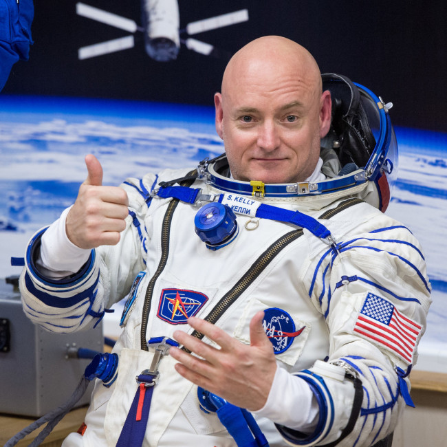 NASA Astronaut Scott Kelly gives a thumbs as he and his fellow crew members, Russian Cosmonauts Gennady Padalka, and Mikhail Kornienko of the Russian Federal Space Agency (Roscosmos) have their Russian sokol suits pressure checked ahead of their launch onboard the Soyuz TMA-16M spacecraft to the International Space Station Friday, March 27, 2015 in Baikonor, Kazakhstan. [Photo: IC]