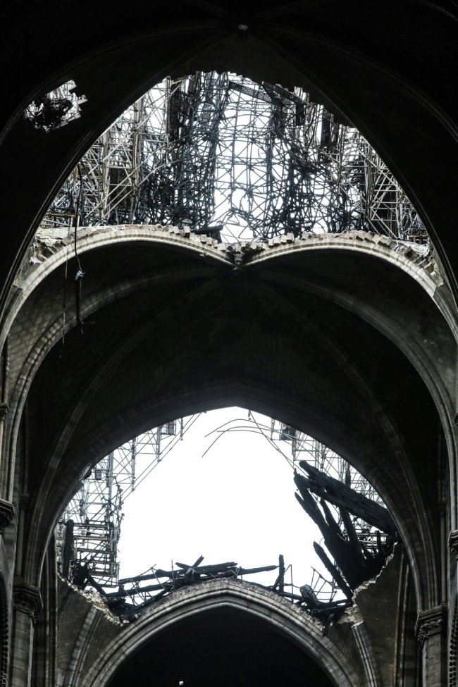 A picture taken on April 16, 2019 shows the partially collapsed vault above the nave of Notre-Dame Cathedral in Paris in the aftermath of a fire that devastated the cathedral. [Photo: AFP]