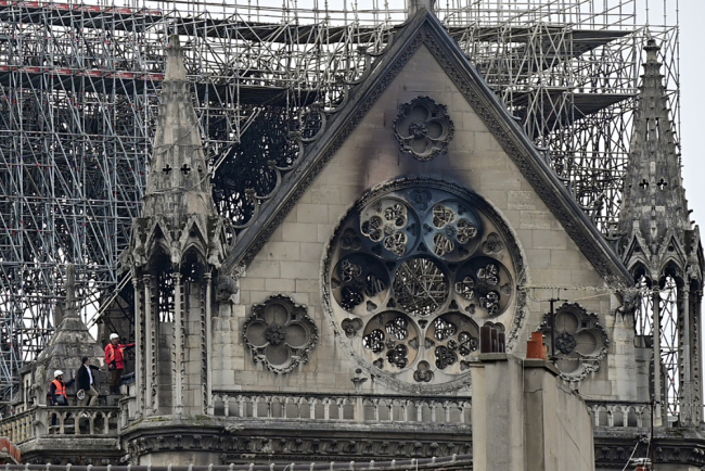 Inspectors are seen on the roof of the landmark Notre-Dame Cathedral in central Paris on April 16, 2019, the day after a fire ripped through its main roof. [Photo: AFP]
