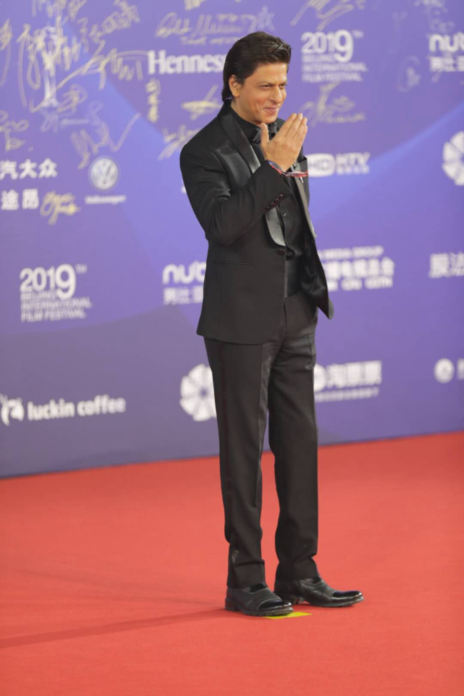 Bollywood's “King Khan” Shah Rukh Khan poses for photo at the red carpet, at the closing ceremony for the 9th Beijing International Film Festival, on April 20, 2019, in Beijing. [Photo: CGTN]