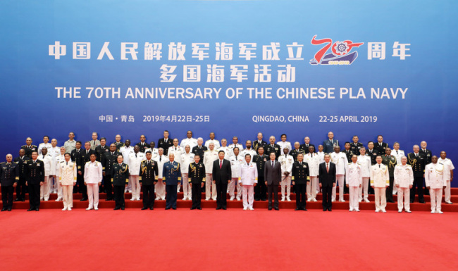 Chinese President and Central Military Commission Chairman Xi Jinping takes a group photo with the heads of foreign delegations invited to participate in the multinational naval events marking the 70th anniversary of the founding of the Chinese People's Liberation Army Navy in Qingdao, Shandong Province on Tuesday, April 23, 2019. [Photo: Xinhua]