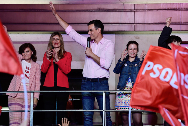 Spanish Prime Minister Pedro and Socialist Party (PSOE) candidate for prime minister Pedro Sanchez (C) waves beside vice-secretary general Adriana Lastra (R) and her wife Begona Gomez (2L) during an election night rally in Madrid after Spain held general elections on April 28, 2019. [Photo: AFP]