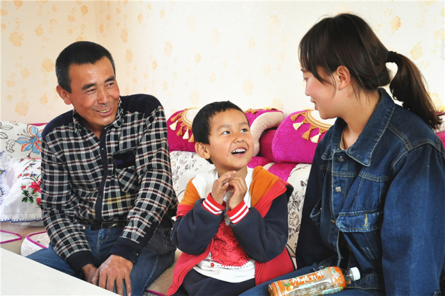 Young village teacher take care of Uyghur children in Xinjiang