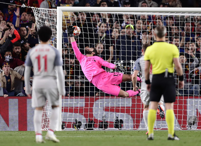 Liverpool goalkeeper Alisson fails to stop Barcelona's Lionel Messi's shot on goal, giving Barcelona a 3-0 lead during the Champions League semifinal first leg soccer match between FC Barcelona and Liverpool at the Camp Nou stadium in Barcelona, Spain, Wednesday, May 1, 2019. [Photo: AP/Manu Fernandez]