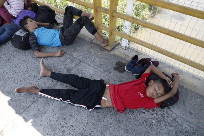 Honduran migrant children rest on the international border bridge in Ciudad Tecun Uman, Guatemala, as they wait to cross into Mexico on April 12, 2019. A group of 350 Central American migrants forced their way into Mexico Friday, authorities said, as a new caravan of around 2,500 people arrived -- news sure to draw the attention of US President Donald Trump. Mexico's National Migration Institute said some members of the caravan had a "hostile attitude" and had attacked local police in the southern town of Metapa de Dominguez after crossing the border from Guatemala.[Photo: AFP]