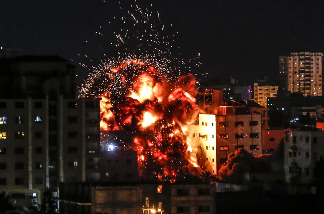 An explosion is pictured among buildings during an Israeli airstike on Gaza City on May 4, 2019. Gaza militants fired a barrage of rockets at Israel, which responded with airstrikes, officials said, as a fragile ceasefire again faltered. [Photo: AFP]