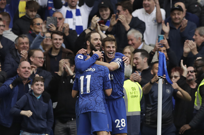 Chelsea's Gonzalo Higuain, left, celebrates with teammate Cesar Azpilicueta, right, and Pedro after scoring his side's third goal during the English Premier League soccer match between Chelsea and Watford at Stamford Bridge stadium in London, Sunday, May 5, 2019. [Photo: AP]