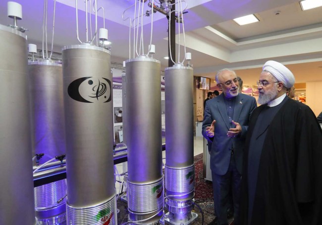 In this file photo made available on April 09, 2019 by the Iranian presidential office, Iranian President Hassan Rouhani (2nd L) listens to head of Iran's nuclear technology organisation Ali Akbar Salehi (R) during the "nuclear technology day" in Tehran. [Photo: AFP]